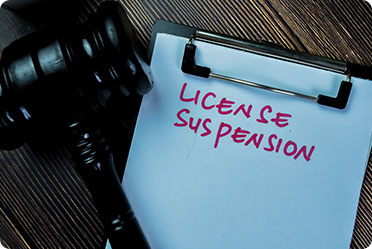 Licence suspension written on a clipboard and gavel - Leckerman Law, LLC