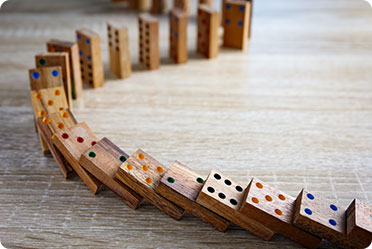 A wooden domino game set arranged on a table - Leckerman Law, LLC