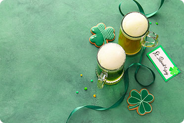 St. Patrick's Day beer mug with a green shamrock design - Leckerman Law, LLC