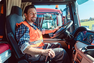 A man sitting in the driver's seat of a truck - Leckerman Law, LLC