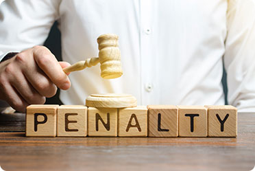 Blocks of Penalty spelling and a man holding a small gavel - Leckerman Law, LLC