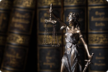 A statue having a court balance and sword - Leckerman Law, LLC