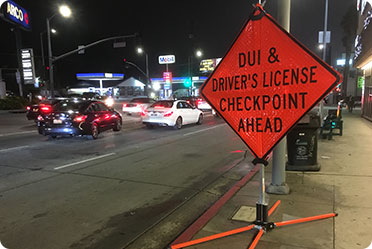Sign board of DUI & drivers license checkpoint ahead - Leckerman Law, LLC