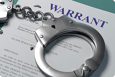 Handcuff with arrest warrent paper - Leckerman Law, LLC