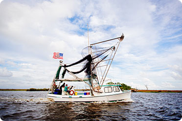 Boat in a water with US flag - Leckerman Law, LLC