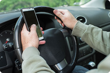 A person is using mobile while driving - Leckerman Law, LLC