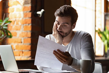 A man in a stress while checking some papers - Leckerman Law, LLC