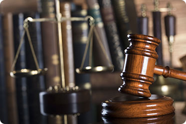 A gavel and a balance on a table - Leckerman Law, LLC