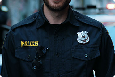 A policeman in a blue uniform - Leckerman Law, LLC