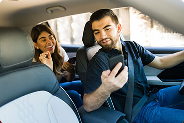 Boy and girl using mobile and gossiping in a car - Leckerman Law, LLC