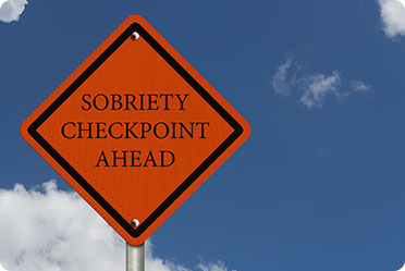 A warning sign of sobriety checkpoint ahead - Leckerman Law, LLC