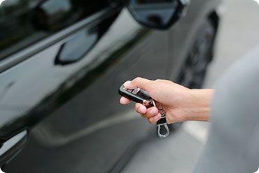 A person holding a key to a black car - Leckerman Law, LLC