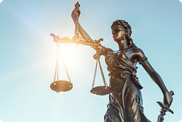 A statue with a scale and sword in hand - Leckerman Law, LLC