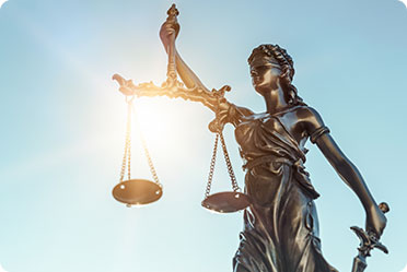 A statue with a scale and sword in hand - Leckerman Law, LLC