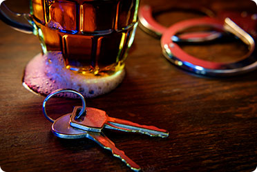 A mug of beer and keys on a table - Leckerman Law, LLC