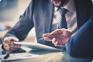 Two men in suits sitting at a table - Leckerman Law, LLC