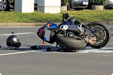 A motorcycle lying on the ground after accident - Leckerman Law, LLC