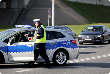 A police officer entering in a car - Leckerman Law, LLC