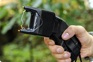 A person holding a stun gun - Leckerman Law, LLC