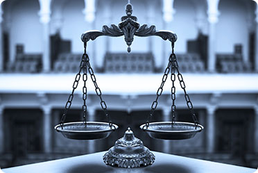 A monochrome image of a balance scale - Leckerman Law, LLC
