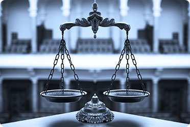 A monochrome image of a balance scale - Leckerman Law, LLC