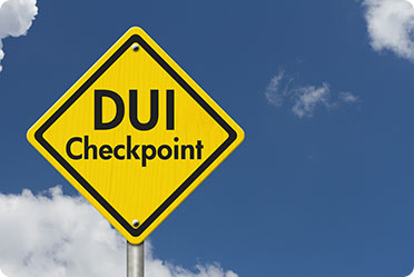 Yellow sign with DUI Checkpoint written on it - Leckerman Law, LLC